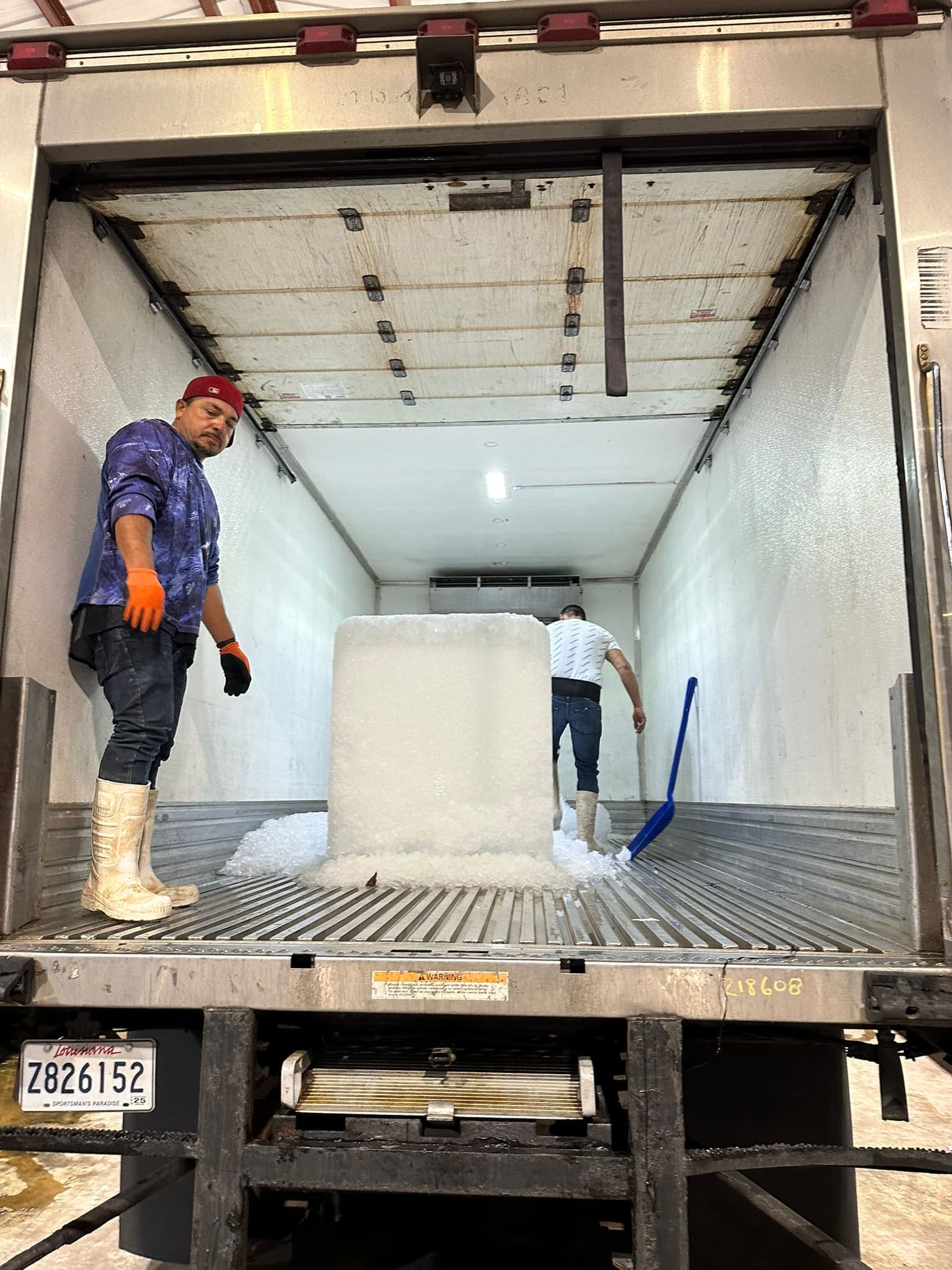 Sacks of live crawfish being iced and loaded for a scheduled wholesale delivery route